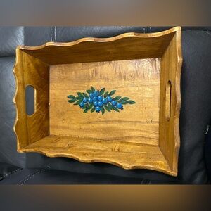 This vintage wooden serving tray features a hand-painted blueberry design.